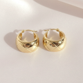 Gold Quilted Huggie Hoop Earrings Flat Lay